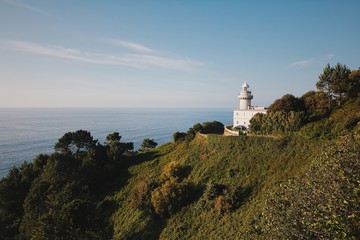 Fototapeta na wymiar Landscape photo of the lighthouse on the hill.