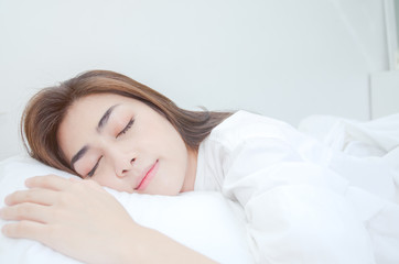 Women wearing white pajamas are resting.