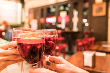 hands toasting with a glass of sangria