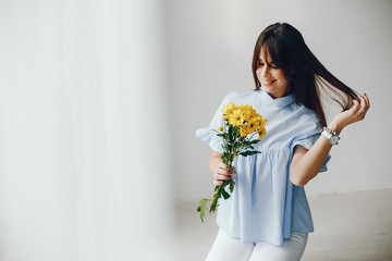 Cute girl with a flowers. Woman at home. Mother's day