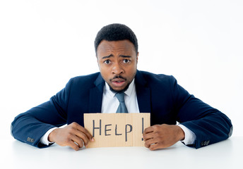 Young Businessman Holding Cardboard With Help Text At Workplace in stress and pressure at work.