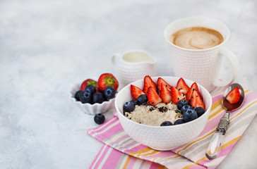 Healthy breakfast with oatmeal porridge, fresh berries and coffee