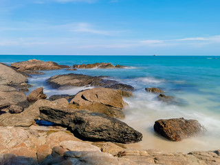 Fototapeta na wymiar Rocks on the beach, Landscape with blue sea and Blue sky