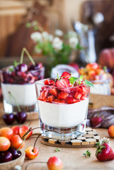 Delicious Italian dessert Panna Cotta with fresh summer berries and fruits