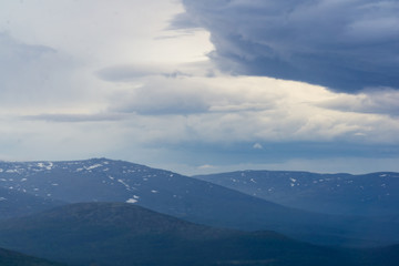 Fototapeta premium Rays of the setting sun over the mountain valley Khibiny