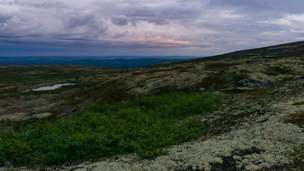 Rays of the setting sun over the mountain valley Khibiny