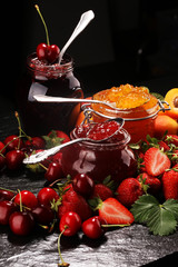 assortment of jams, seasonal berries, apricot, mint and fruits. marmalade or confiture