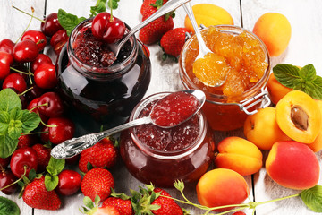 assortment of jams, seasonal berries, apricot, mint and fruits. marmalade or confiture