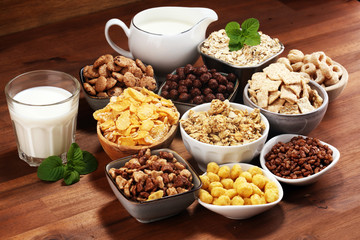 Cereal. Bowls of various cereals and milk for breakfast. Muesli with kids cereals.