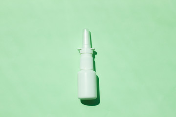 White medical nasal spray bottle,a remedy against allergies and runny nose, colds, viral diseases.