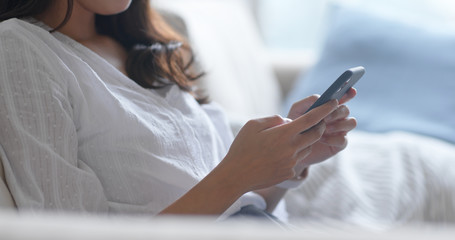 Woman use of mobile phone online at home