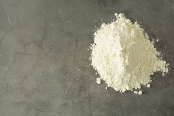 Pile or heap of rice flour isolated ondark background. Gluten free flour. Healthy food.