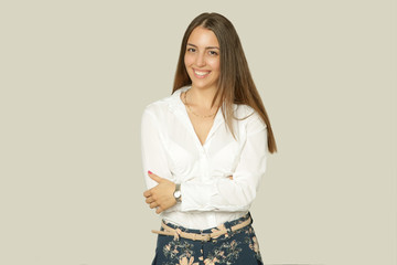 Beautiful attractive young woman portrait. Business woman with light smile wearing a white shirt