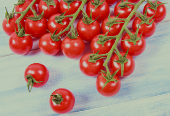 Fresh cherry tomatoes on a wooden background.