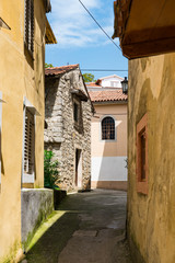 colorful houses in small street of historical town Lovran, Croatia