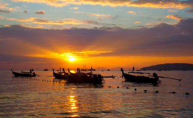 Fototapeta na wymiar Longtail boats on seashore at sunset, Thailand