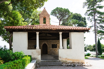 small church Crkvica sv. Trojstva, between pine trees in Lovran, Croatia