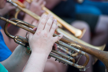 Obraz na płótnie Canvas Closeup of hands on musician on trumpet in tne street