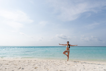 Fototapeta na wymiar Meditation - Yoga woman meditating at serene beach.