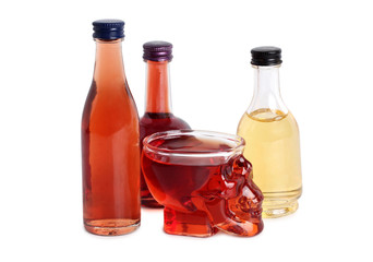 Wine glass in shape of a skull with red wine on a white background