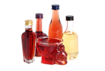 Wine glass in shape of a skull with red wine on a white background