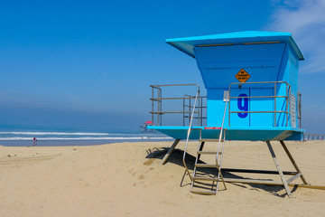 Lifeguard tower on the Huntington Beach during sunny day. Southeast Los Angeles, California, USA.