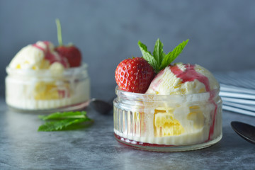 Delicious vanilla ice cream with mint leaves and strawberries