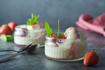 Delicious vanilla ice cream with mint leaves and strawberries, copy space. Summer dessert.