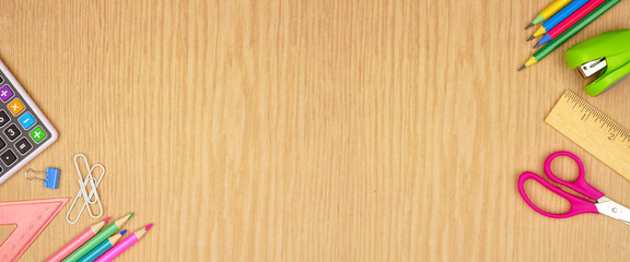 School supplies double corner border banner. Overhead view on a wood background with copy space. Back to school concept.