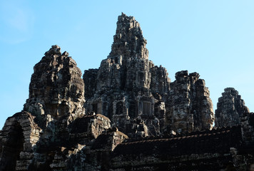 Fototapeta na wymiar Monumental ancient temple of Bayon in Cambodia. Medieval temple in Indochina. Architectural art of ancient civilizations. Bayon temple in Angkor Thom. Face towers.