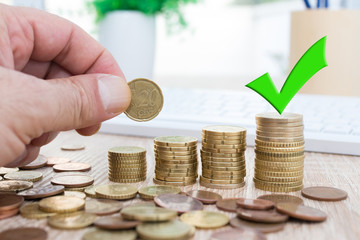 coins and money stacked with sign of okay, savings and finances