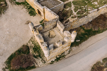 Aerial top view of ruins of medieval castle or fortress tower
