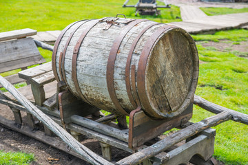 Old wine barrel on village background