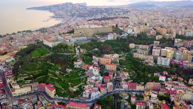 Aerial, drone shot, tilting over buildings and architecture, in the city of Napoli, on a sunny, summer day, in Naples, Italy