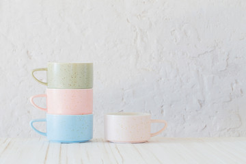 modern ceramic cups on background white wall
