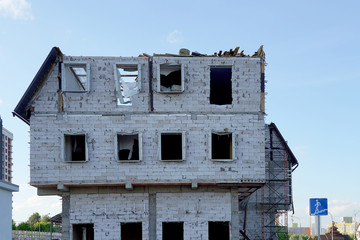 The destruction of a multi-storey building. The house of the foam block without windows and facade. No roof