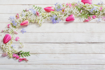 spring flowers on white wooden background