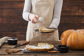 woman cooks pumpkin pie
