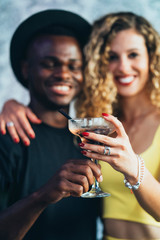 Smiling multicultural couple in love on the party