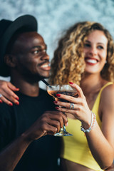 Smiling multicultural couple in love on the party
