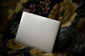 Сlosed laptop on the couch. Freelance at home.