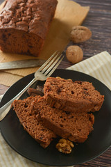 Piece of chocolate cake , fudge or pound cake. Wooden background.