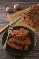 Piece of chocolate cake , fudge or pound cake. Wooden background.