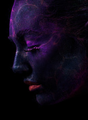 Face of woman with violet paint