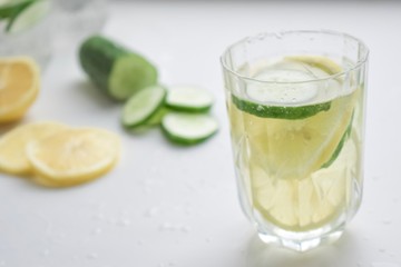 Transparent glass of lemonade with sliced lemon