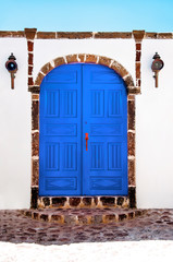 Beautiful old blue door on white facade of greek architecture, Santorini island, Greece, Europe....