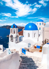 Traditional and famous houses and churches with blue domes over the Caldera, Oia, Santorini, Greece island, Aegean sea. Beautiful view of White Greek architecture. Travel, Famous travel destination