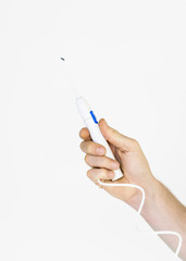 male hand holding oral irrigator on grey background
