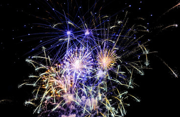 Colorful fireworks in the sky on black background. Celebratory salute, fireworks
