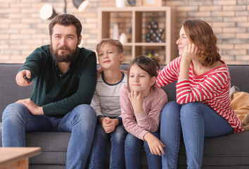 Happy family watching TV at home